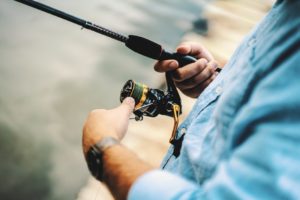 A man fishing from a dock.