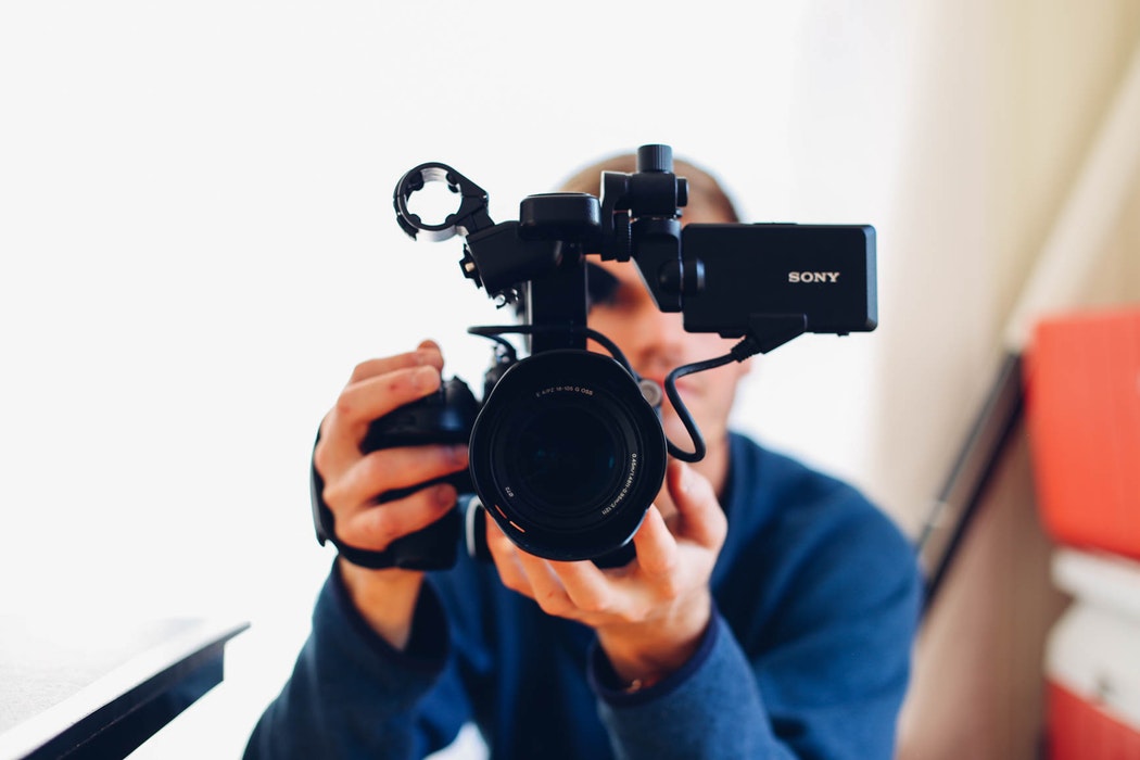 A man holding up a camera.